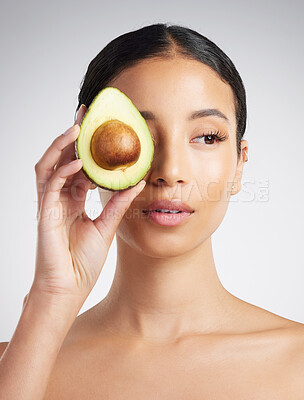 Buy stock photo Woman, thinking and skincare in studio with avocado, antioxidants and hydration benefits for beauty. Female person, fruit or vision with natural cosmetics, wellness or dermatology on white background