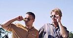 Sunglasses, men and college student on campus outdoor for university, opportunity and confidence. View, study break and happy friends in park for learning with knowledge, education and scholarship