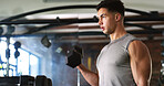 Fitness, sweating or man with dumbbell in gym, strength challenge or routine for muscle development. Serious, bicep training or bodybuilder with weightlifting in sport club, active or intense workout