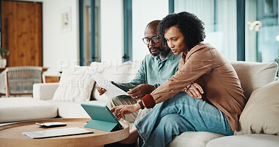 Buy stock photo Paperwork, home and couple with tablet for financial feedback, insurance policy and tax review. African man, mature woman and savings discussion for debt planning, document or bills with tech on sofa