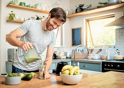 Buy stock photo Earphones, man and pour green smoothie in home for breakfast shake, healthy diet and happy. Music, person and smile with nutrient beverage in blender for detox drink, digestive health and weight loss