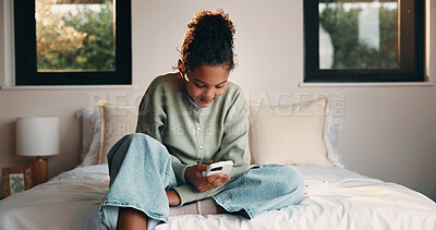 Buy stock photo Relax, reading and girl with mobile on bed, scroll social media and connection for browsing internet. Smile, phone and child with online platform for message, watch video and streaming movie in home