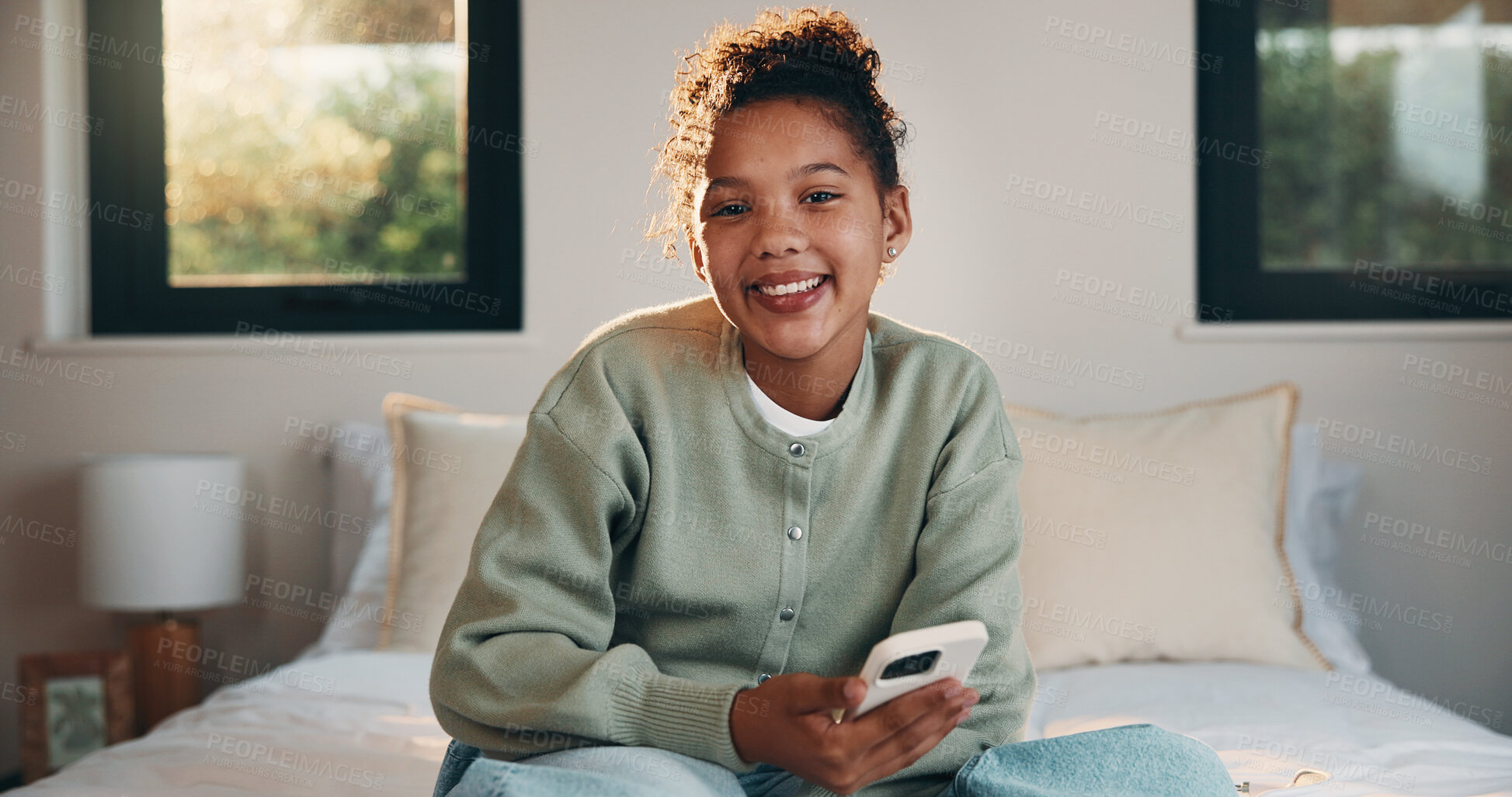 Buy stock photo Phone, happy and portrait of teenager on bed in home with social media on mobile app with relax. Smile, calm and girl in bedroom with cellphone for texting, chatting or connectivity in house.