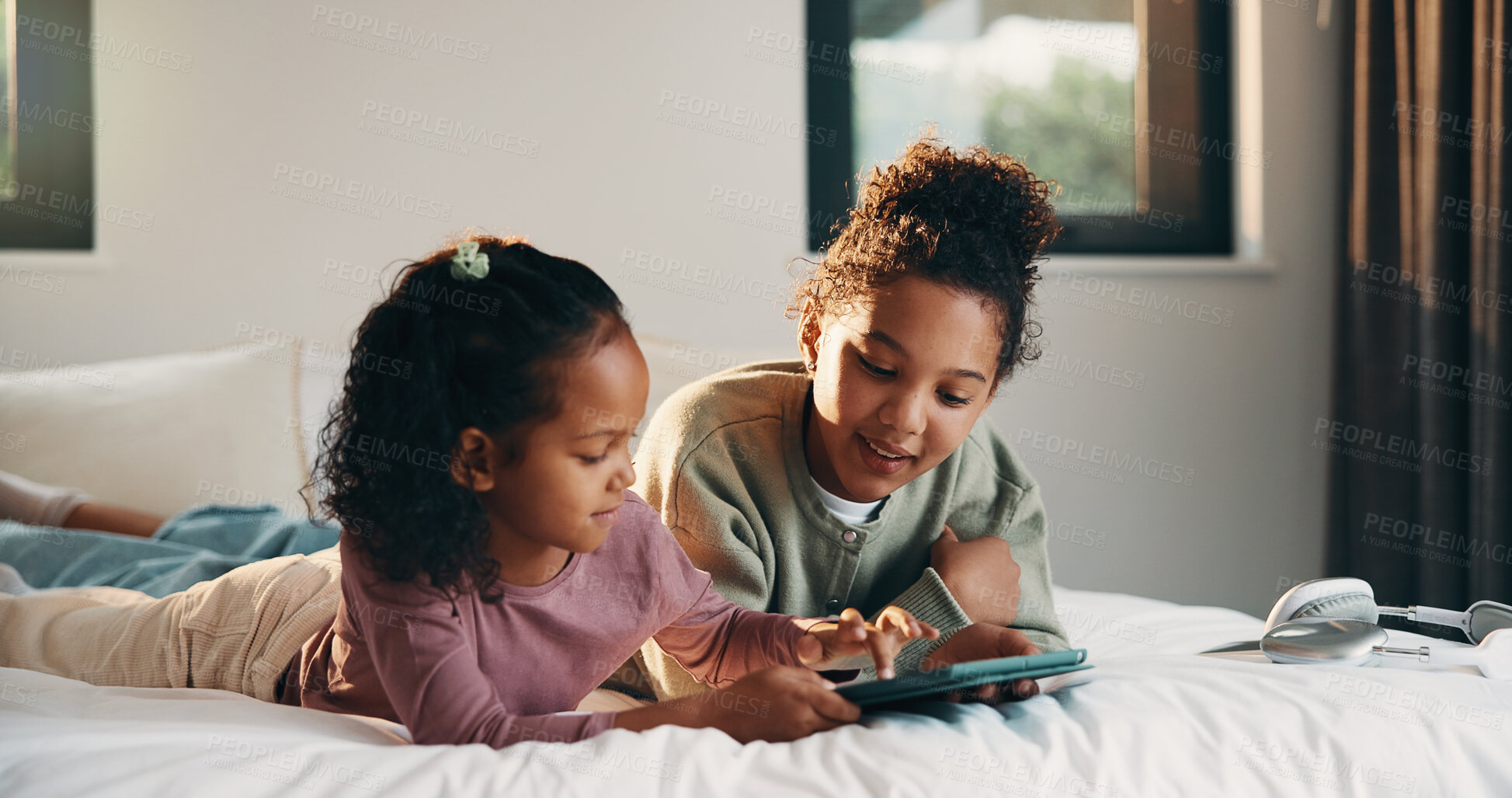 Buy stock photo Relax, sister and tablet with kids on bed in home for holiday, morning break or weekend. App, comfortable and streaming with girl children in bedroom of apartment for development, future or growth