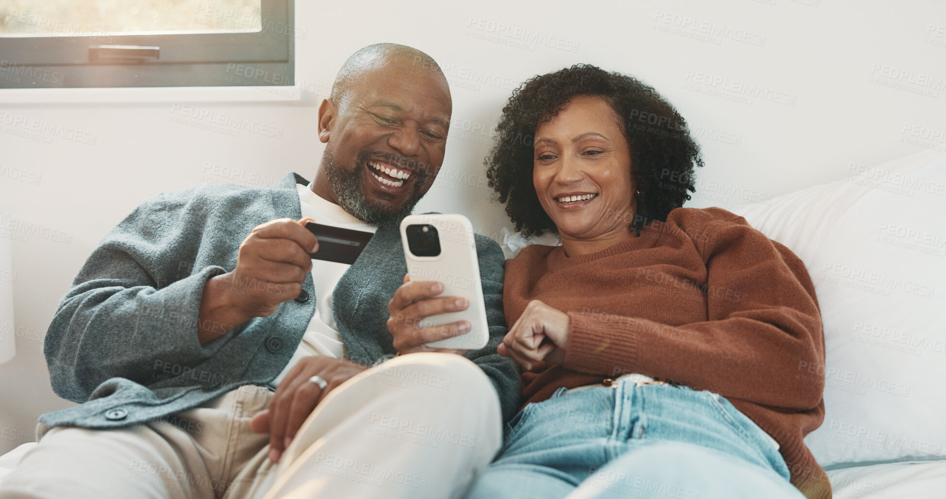 Buy stock photo Couple, phone and credit card in home bedroom for online shopping, subscription and payment. Laughing, African man and woman with technology for banking app, e commerce and relax on internet in house