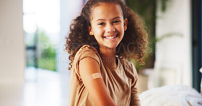 Buy stock photo Girl, smile and plaster for vaccine in home with flu shot, healthcare and portrait in bedroom. Happy kid, bandage and cover for injection for immune system boost, virus or germs at house in Brazil