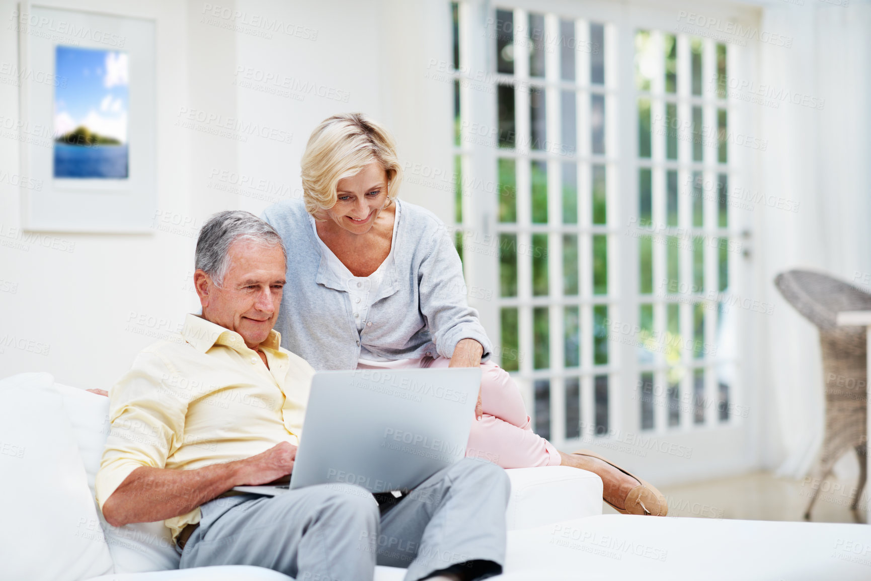 Buy stock photo Laptop, planning and search with old couple on sofa for retirement trip, bucket list destination or love. Travel itinerary, senior vacation or online with elderly man and woman in living room in home