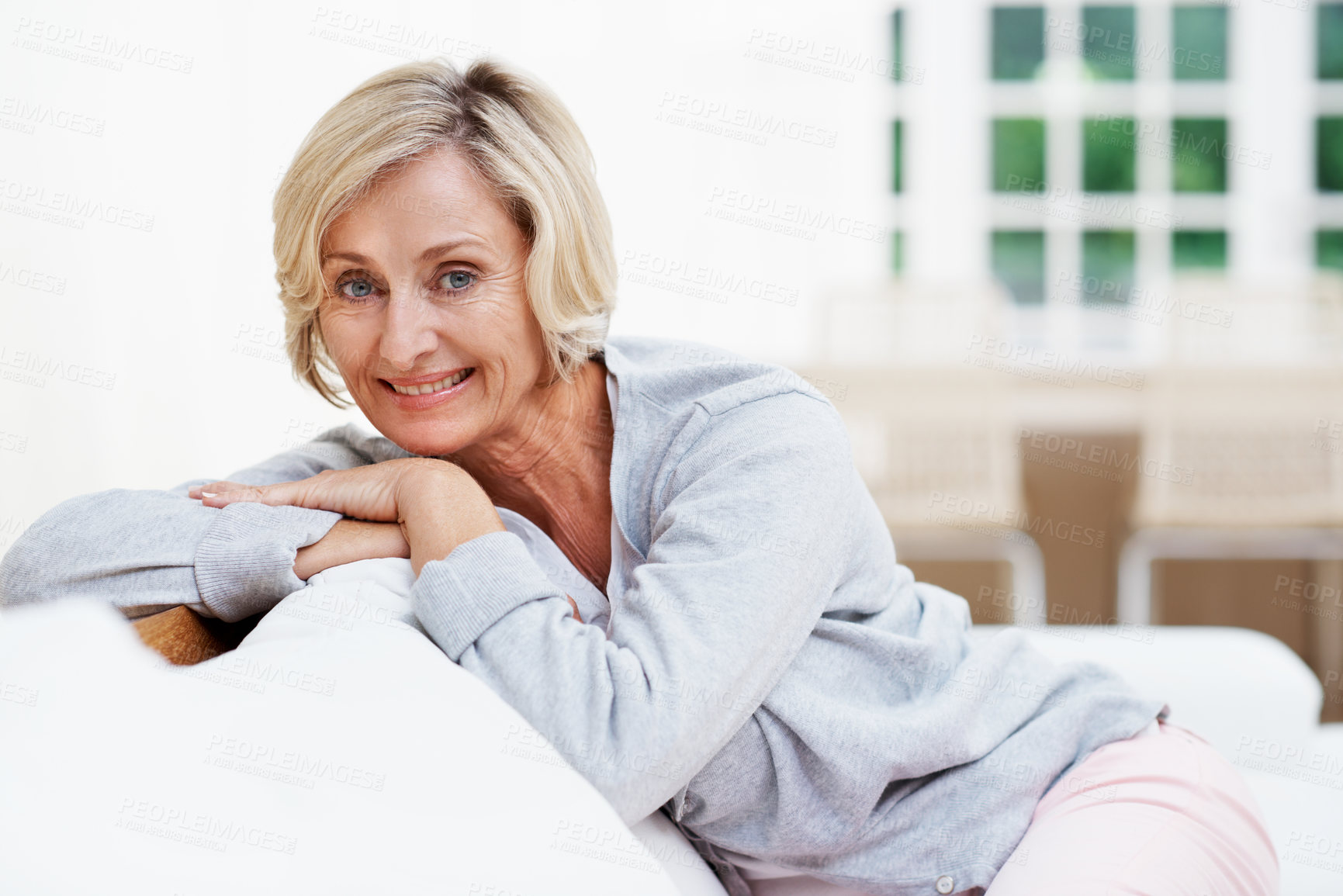Buy stock photo Smile, comfortable and portrait of old woman on sofa in home for weekend break, pride and wellness. Confidence, retirement and happy with senior person in living room for satisfaction and calm