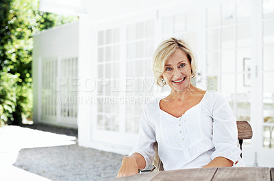 Buy stock photo An attractive mature woman relaxing outside her home - portrait