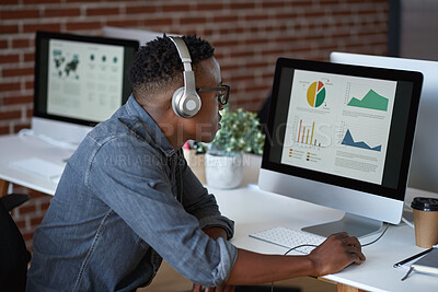 Buy stock photo Headphones, computer screen and man in office, charts for global trading or app for podcast. African person, trader or employee in workplace, pc or graphs for revenue growth or subscription for radio