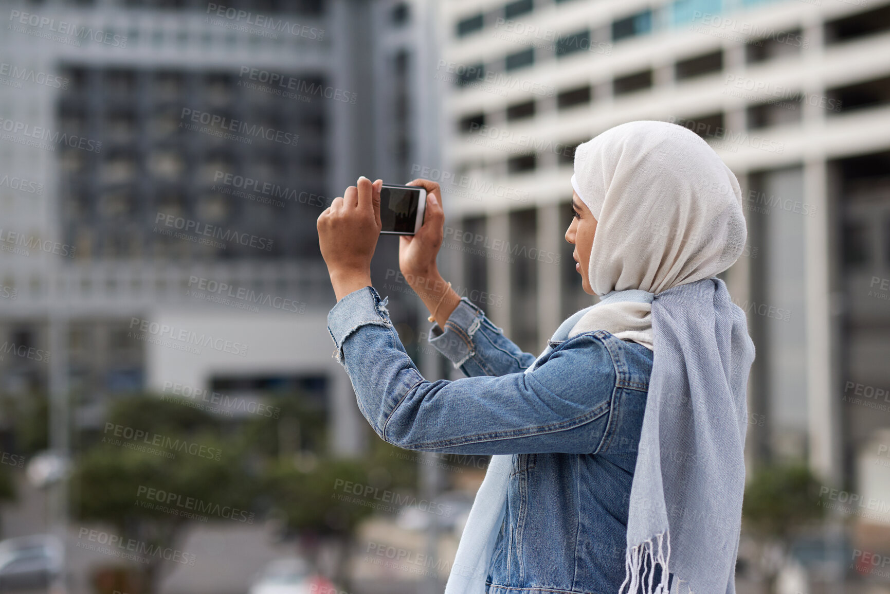 Buy stock photo Muslim woman, phone and picture in city, travel and capture memory for vacation adventure outdoor. Islamic person, mobile and photography in town for sightseeing, social media update and holiday post