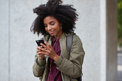 Buy stock photo Earphones, student and black woman with phone in city, reading message and university app for commute. Class schedule, smile and scholar with tech for morning travel, streaming music and texting