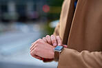 Businessman hands using smart watch in city