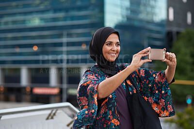 Buy stock photo Travel, photo and outdoor with Muslim woman, phone to capture memory and vacation for break. Happy, influencer or person with social media, post update and sightseeing with live streaming in New York