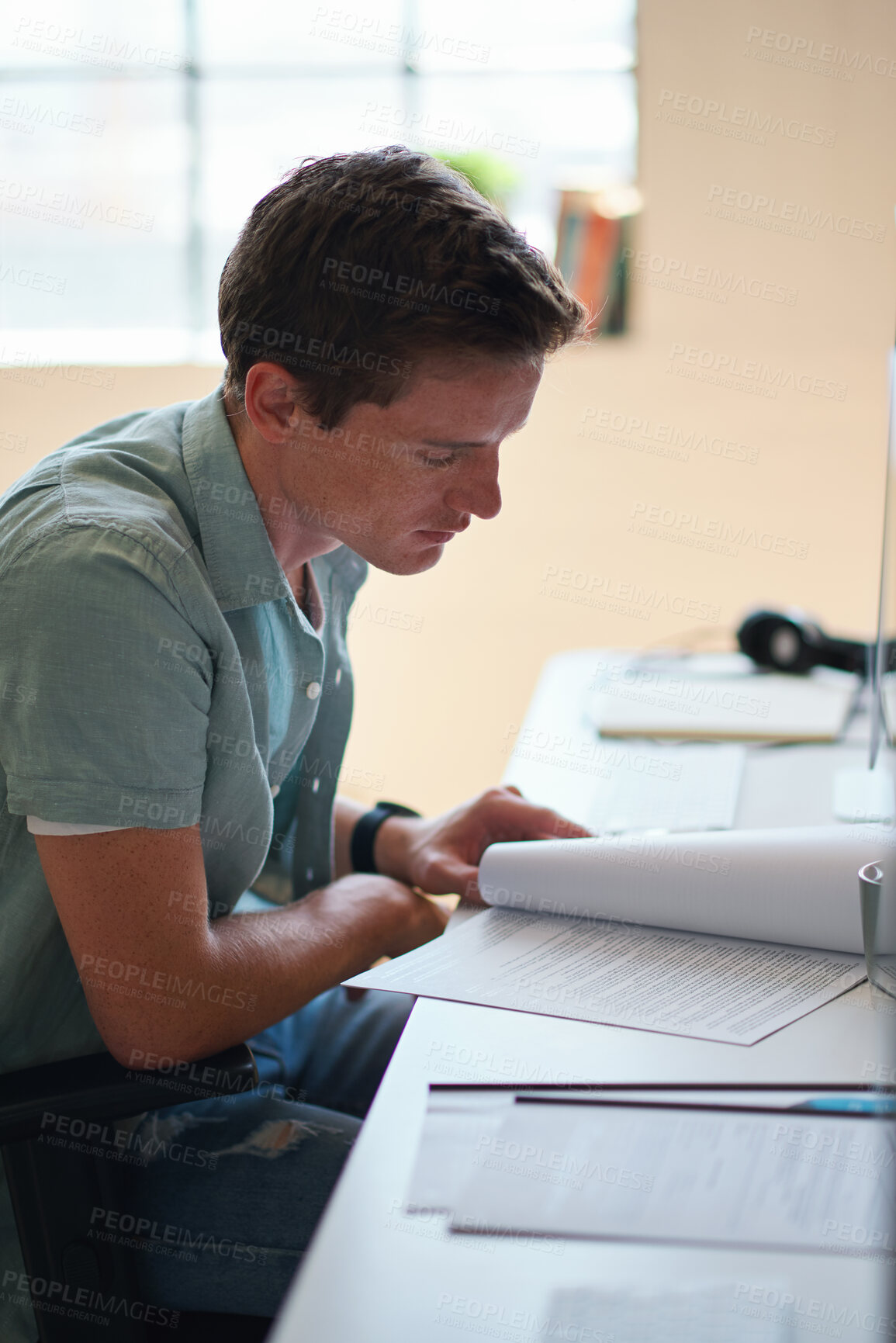 Buy stock photo Reading, student and man with document in home, course revision and learning for exam preparation. Education, studying and scholar with practice test for knowledge, college assignment or lesson notes