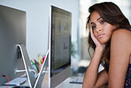 Bored business woman looking out window daydreaming sitting at desk in office