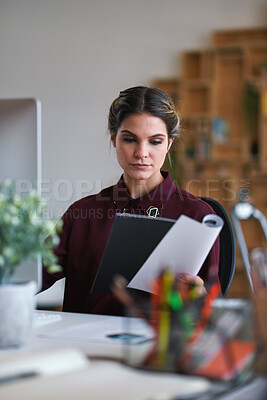 Buy stock photo Creative, businesswoman and reading documents in office, brand manager and planning for ad campaign. Serious, person and paperwork with marketing strategy, information and research for assignment