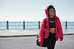 Healthy african american woman looking confident after workout on waterfront female athlete smiling enjoying summertime fitness