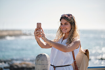 Buy stock photo Travel, beach and happy woman with selfie on promenade for sightseeing, capture moment or picture. Female person, tourist or traveler with smile for photography or social media post on ocean coast