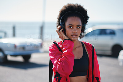 Buy stock photo Teenager, girl and headphones outdoor with fitness, planning workout and listen to music playlist. Black person, active student and audio tech by promenade with wellness, radio or vision for exercise