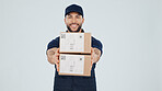 Logistics, delivery man and smile with boxes in studio for package, safe transport or supply chain. Space, happy courier and giving parcel on white background for shipping, distribution and portrait