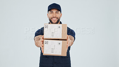 Buy stock photo Logistics, delivery man and smile with boxes in studio for package, safe service or supply chain. Space, happy courier and giving parcel on white background for shipping, distribution and portrait