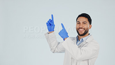 Buy stock photo Doctor, portrait or pointing up with man in studio for marketing or presentation on a white background. Male person, healthcare worker or showing mockup space with smile for advertising or option
