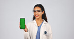 Scientist, green screen and woman with phone for research, mockup space and medical development. Science, smile and person with mobile to show experiment info, studio and portrait on white background