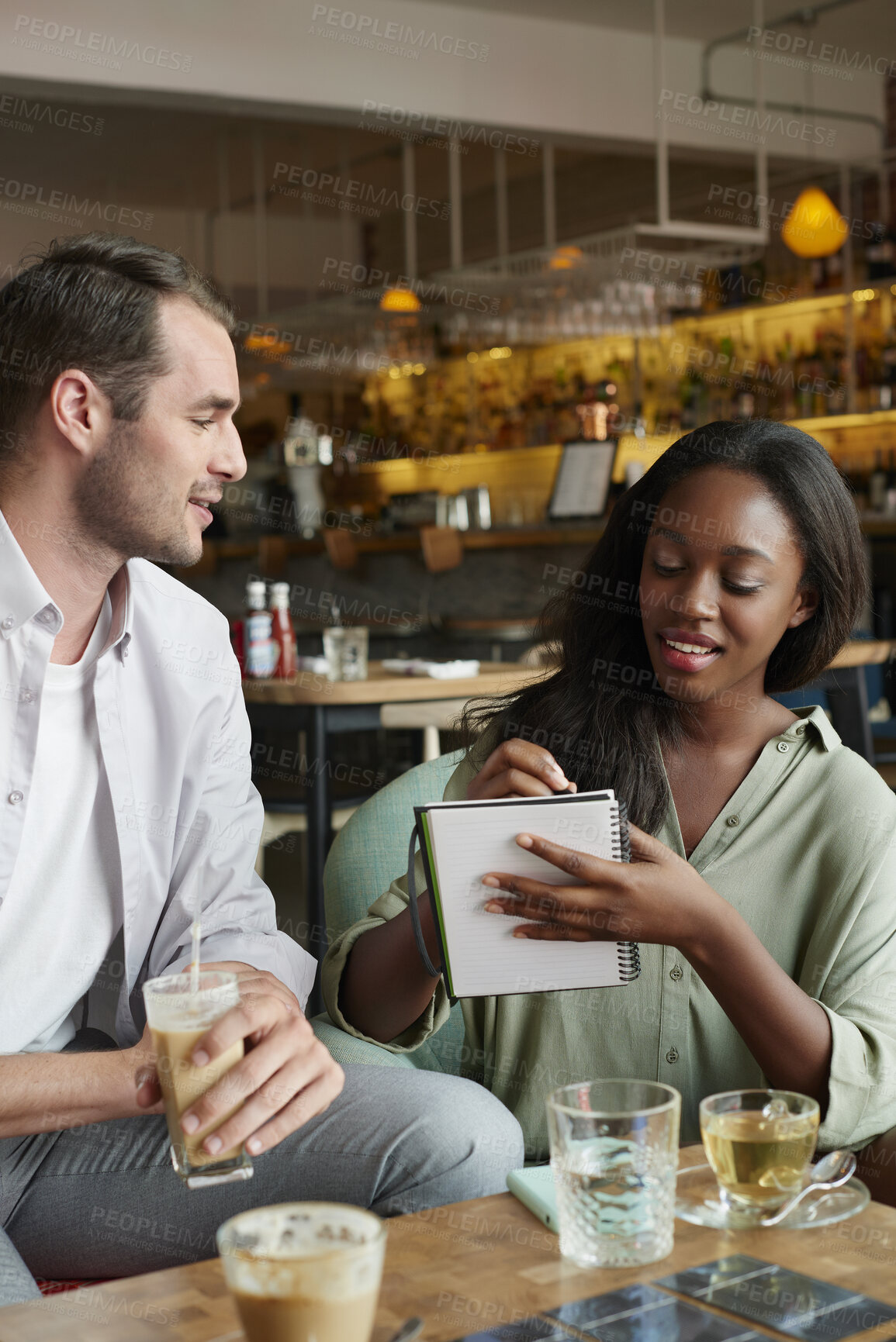 Buy stock photo Team, writing or remote work in cafe with notebook, ice coffee and plan for public relations startup. Freelancer, people and meeting notes in diner with drinks, diary and brainstorming for PR agency.