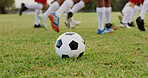 People, feet and soccer ball on field with practice, outdoor training and preparation for tournament. Football player, team and shoes on grass with sports equipment, exercise and fitness for game.