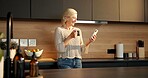 Happy, coffee or woman in kitchen with phone, funny message or post update on social media. Smile, tech or mature person in house with warm beverage, meme reaction or chat notification on digital app