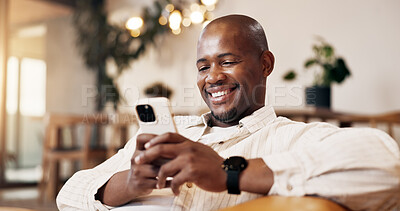 Buy stock photo Phone, browsing and black man in living room with smile, check online dating profile and social media. Bokeh, happy person and tech in home with mobile app, text message notification or digital chat.