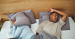 Snore, couple and woman with pillow in bed for disturbance, noise and annoyed for sleep apnea. Home, above and people cover ears in bedroom with frustrated, upset and irritated for sleepless night