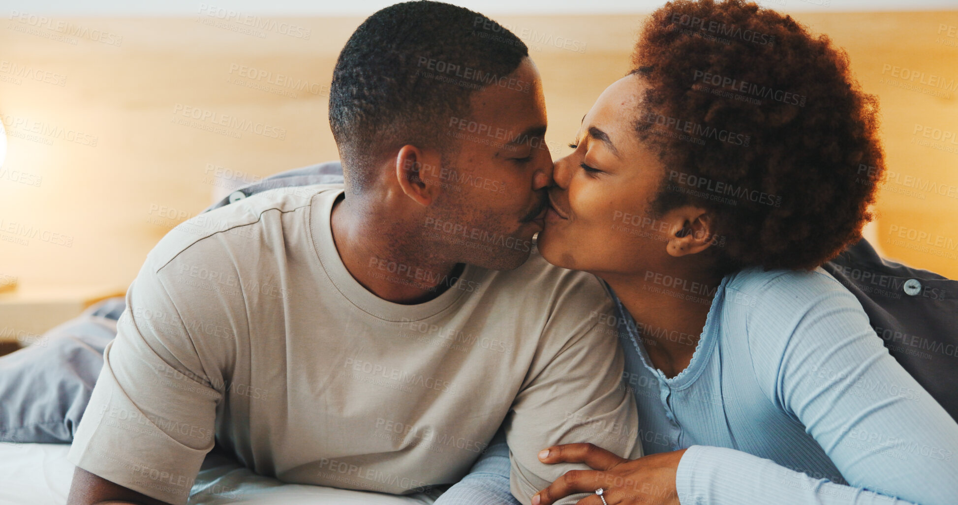 Buy stock photo Wake up, kiss or couple in bed with love, partner care or bonding together in connection. Tender, loyalty or African people with affection, romantic moment or morning routine in healthy relationship.