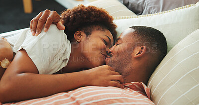 Buy stock photo Affection, kiss and relax with black couple in bed at apartment together for bonding, connection or rest. Love, morning and wake up with happy people in bedroom of home for break, holiday or romance