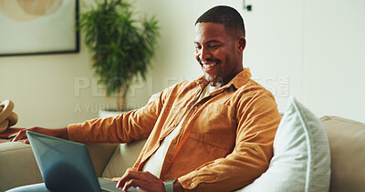 Buy stock photo Laptop, happy and man on sofa in home for remote work on software development project in living room. Relax, computer and male frontend engineer with online programming for freelance career in house.