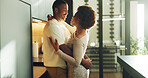Happy, couple and hug in kitchen with connection, bonding together and relax on weekend break in home. Married black people, smile and embrace in house with relationship commitment, loyalty and care.