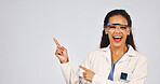 Portrait, pointing and scientist by mockup space in studio with goggles for medical research. Woman, healthcare presentation and biologist with ppe, lab coat or safety gear on white background.