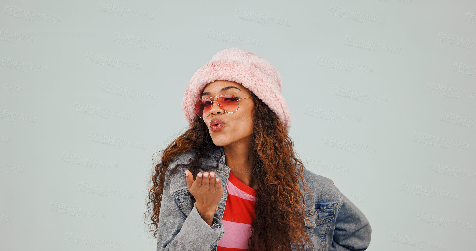 Buy stock photo Fashion, portrait or woman blowing kiss in studio for clothing or love on a gray background. Female person, hipster or funky style with smile, sunglasses or affection for cool accessory, swag or vibe