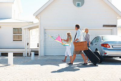 Buy stock photo Smile, travel and family outdoor with luggage, road trip and adventure at holiday house. Parents, walking and daughter at getaway retreat with suitcase, vacation weekend and parked car at destination