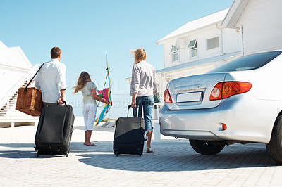 Buy stock photo Back, travel and family outdoor with luggage, road trip and adventure at holiday beach house. Blue sky, parents or child at getaway retreat with suitcase, vacation break and parked car at destination