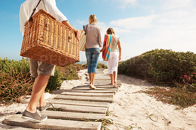 Buy stock photo Holiday, family and basket on coast path for summer getaway, weekend break and relationship. Back, child and parents with travel adventure on boardwalk for beach picnic, vacation and outing arrival