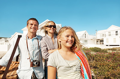 Buy stock photo Happy, parents and child for holiday at coast with picnic basket, sightseeing and weekend break. Support, relationship and people with kid outdoor for summer vacation, view or ready for family outing
