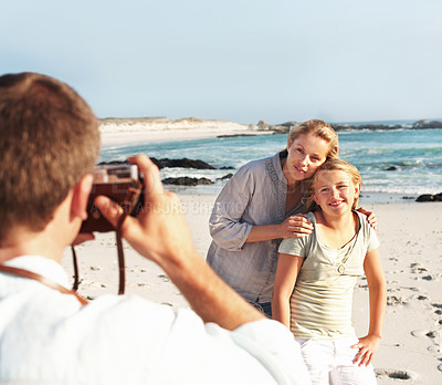 Buy stock photo Happy, photography and family at beach with camera, picture and capture moment on holiday. Smile, mother and daughter at sea with photoshoot, travel blog and bonding together on tropical vacation
