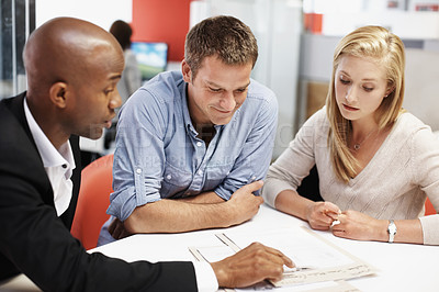 Buy stock photo Reading, documents and financial advisor with couple in meeting, explain and plan for house purchase. People, listening and asset management with paperwork, chat and budget strategy for homeownership