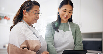 Buy stock photo Cooking, old woman and daughter with tablet in kitchen, bonding and searching for recipe on website. Happy people, online and meal prep with senior mom, family and skill development with tips in home