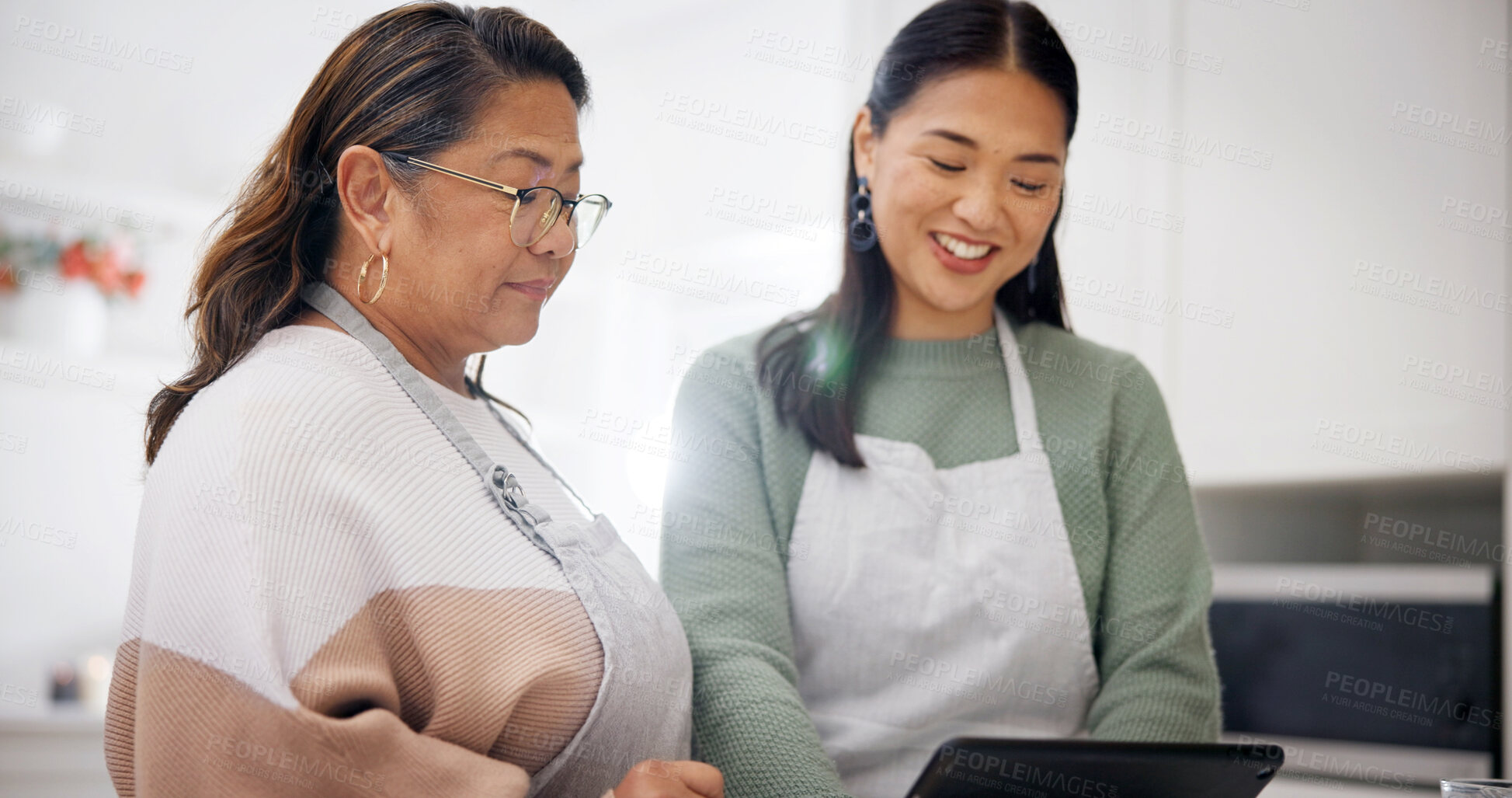Buy stock photo Cooking, old woman and daughter with tablet in kitchen, bonding and searching for recipe on website. Happy people, online and meal prep with senior mom, family and skill development with tips in home