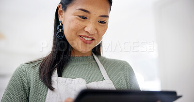 Buy stock photo Smile, tablet and woman in kitchen for recipe, cooking tutorial or digital app for meal prep. Blog, tech and reading in home for nutrition info, website or social media for diet guide or tips