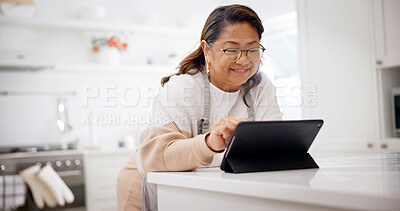 Buy stock photo Smile, tablet and senior woman in kitchen for recipe, cooking tutorial or digital app for meal prep. Food blog, scroll and person in home for nutrition info, website or social media for diet guide