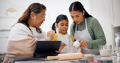 Buy stock photo Baking, old woman and child with tablet in kitchen, talking or instructions for dessert preparation. People, online and meal prep with grandma, tips and learning culinary skills with tech in home